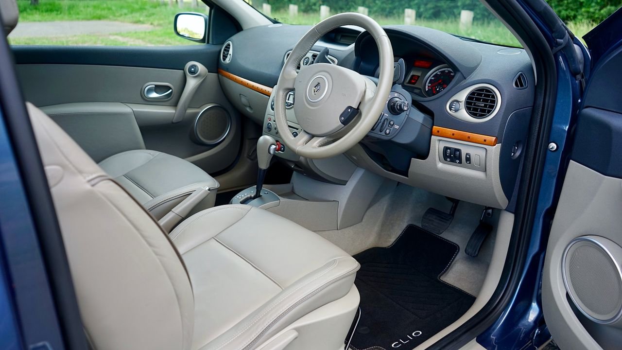 Explore the detailed view of a car interior featuring a modern steering wheel and dashboard.